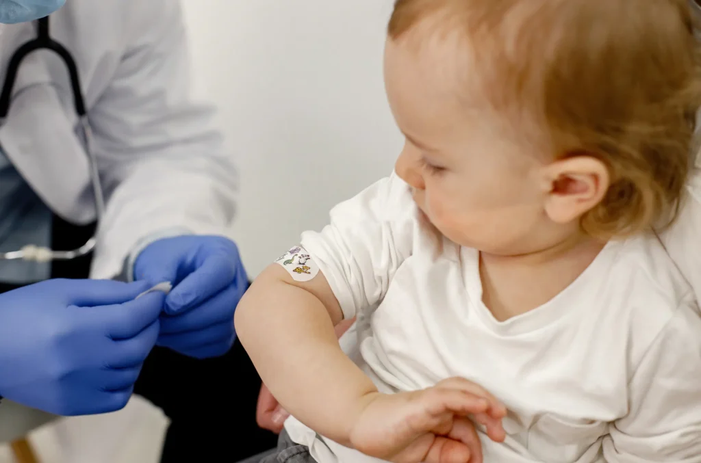 A healthcare professional checks a baby as part of a lead test and evaluation process.