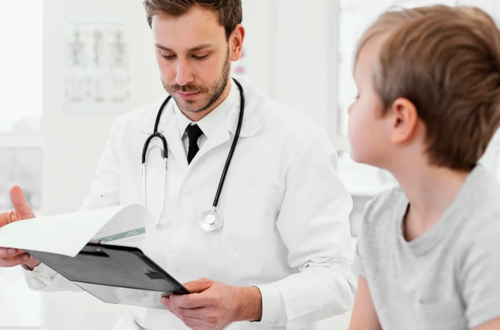 A physician engages in conversation with a young boy regarding lead testing and evaluation. 