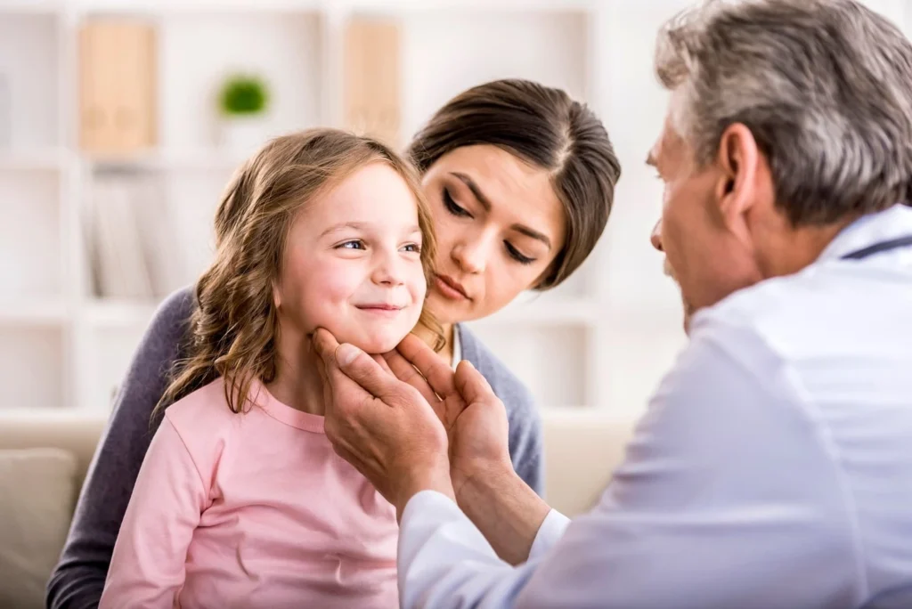 A physician inspects a child while conducting an evaluation for ADHD in children.