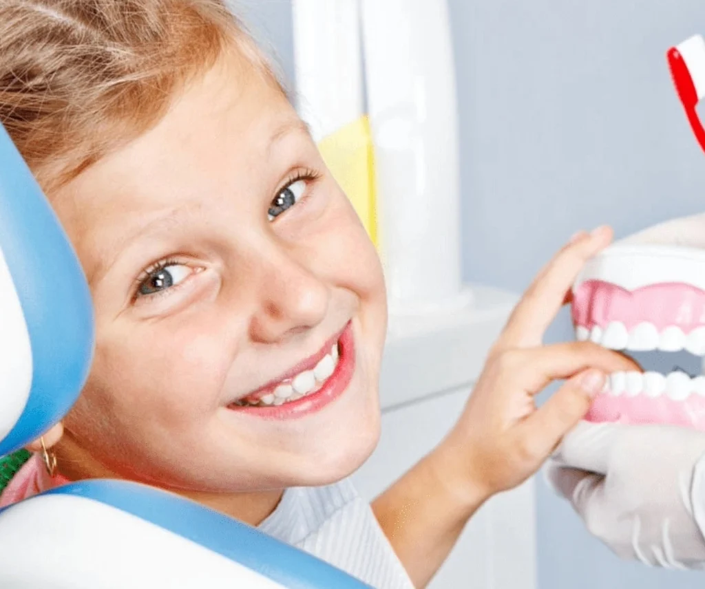 A smiling young girl with her toothbrush highlights the significance of dental care and Treatment childhood caries