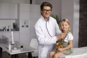 A doctor examines a child holding a toy, highlighting the caring environment of a pediatric clinic.