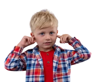 A young boy with blond hair holds his hands over his ears, signaling the need for earwax removal in children.