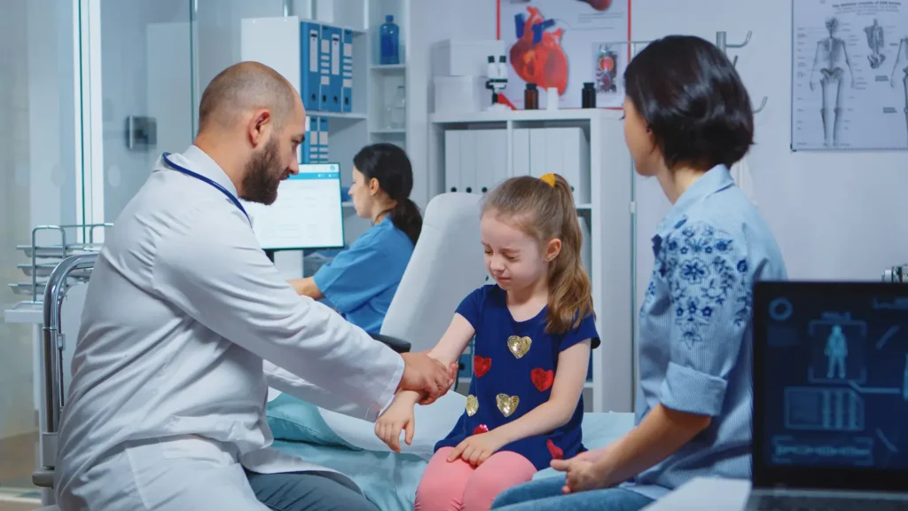 A doctor conducts a sports physical examination on a young girl, ensuring her health and fitness for athletic activities.