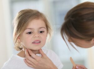 The image depicts a young girl with Strep Throat 