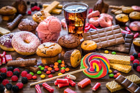 The image shows sugary foods like candy and soda, causing tooth decay.