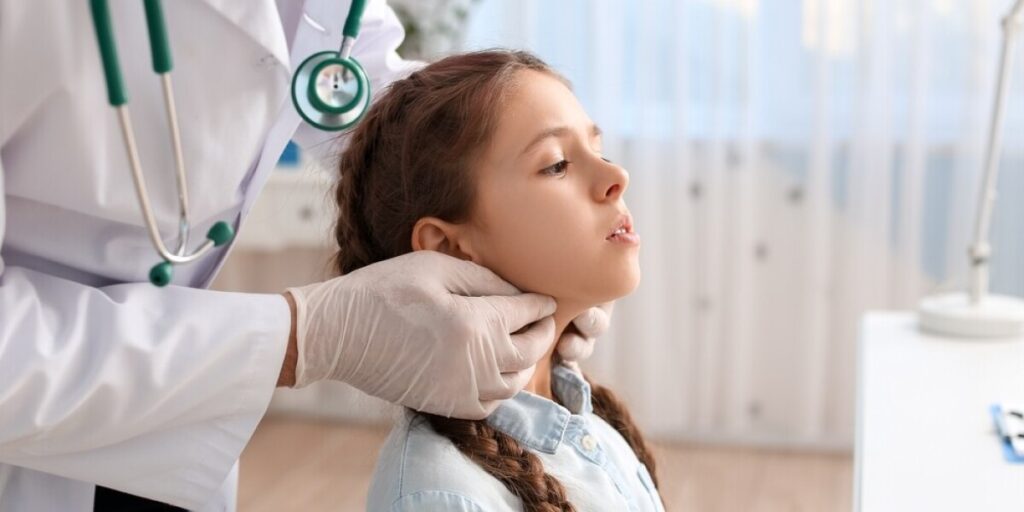 a young girl getting her annual medical check-up by a doctor Copy text