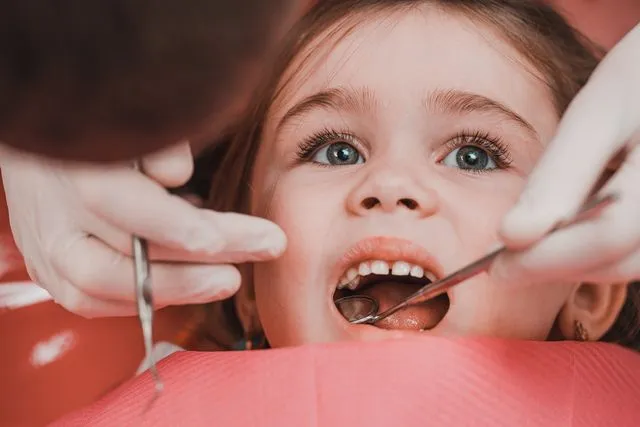 Girl receiving pediatric dental procedures for proper oral care and a healthy smile.